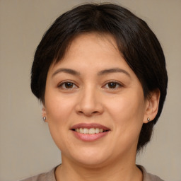 Joyful white adult female with medium  brown hair and brown eyes