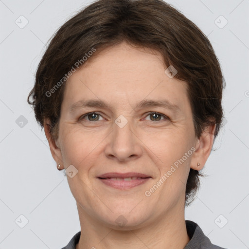 Joyful white adult female with medium  brown hair and grey eyes