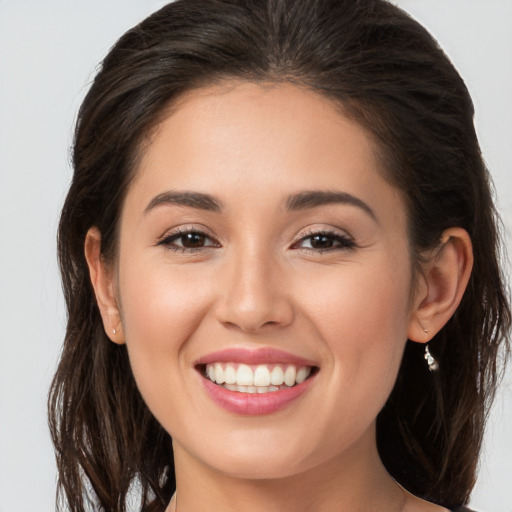 Joyful white young-adult female with long  brown hair and brown eyes