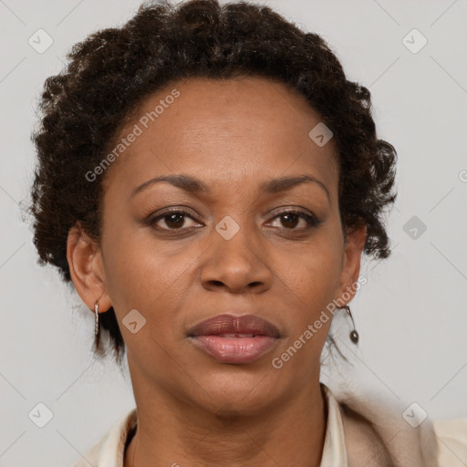 Joyful black adult female with short  brown hair and brown eyes