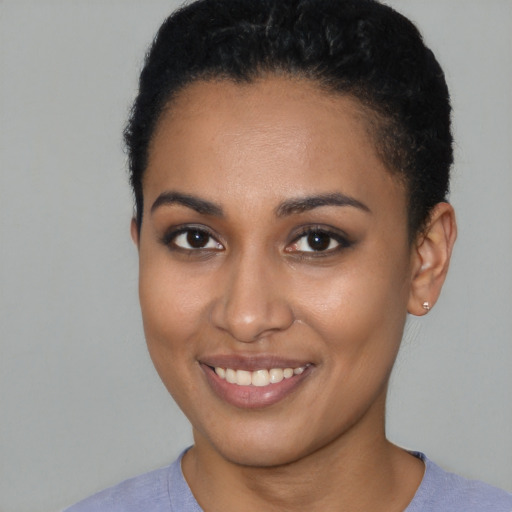 Joyful latino young-adult female with short  brown hair and brown eyes