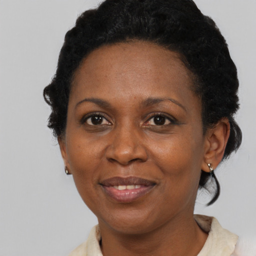Joyful black adult female with short  brown hair and brown eyes