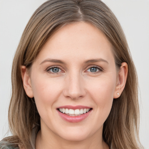 Joyful white young-adult female with long  brown hair and grey eyes