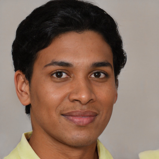 Joyful latino young-adult male with short  brown hair and brown eyes