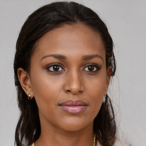 Joyful black young-adult female with medium  brown hair and brown eyes
