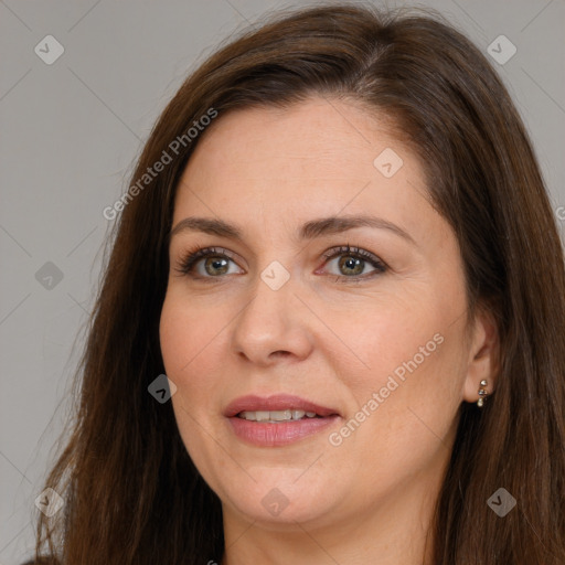 Joyful white adult female with long  brown hair and brown eyes