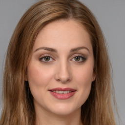 Joyful white young-adult female with long  brown hair and green eyes