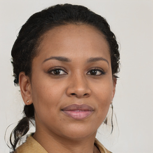 Joyful black young-adult female with medium  brown hair and brown eyes