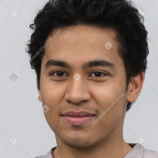 Joyful latino young-adult male with short  brown hair and brown eyes