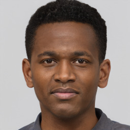 Joyful latino young-adult male with short  brown hair and brown eyes