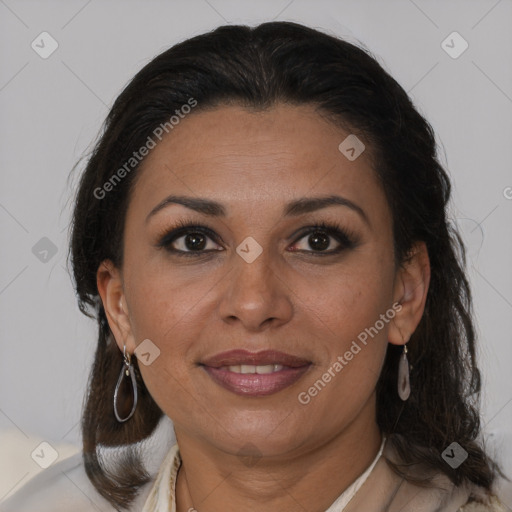 Joyful latino adult female with medium  brown hair and brown eyes