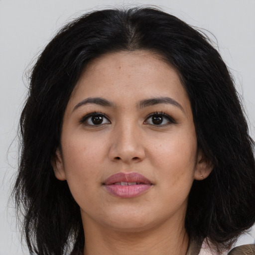Joyful asian young-adult female with long  brown hair and brown eyes