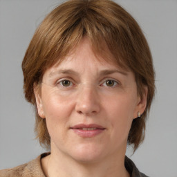 Joyful white adult female with medium  brown hair and grey eyes