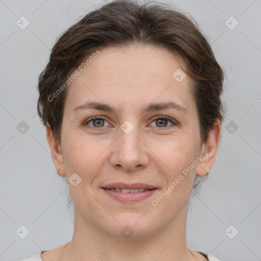 Joyful white adult female with short  brown hair and grey eyes