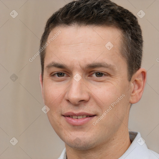 Joyful white adult male with short  brown hair and brown eyes