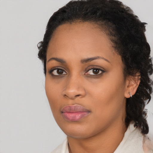 Joyful black young-adult female with medium  black hair and brown eyes