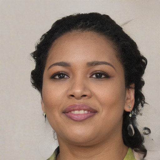 Joyful black young-adult female with medium  black hair and brown eyes