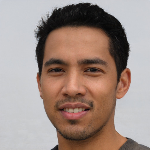 Joyful asian young-adult male with short  black hair and brown eyes