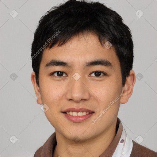 Joyful asian young-adult male with short  black hair and brown eyes