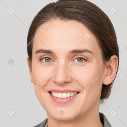 Joyful white young-adult female with medium  brown hair and grey eyes