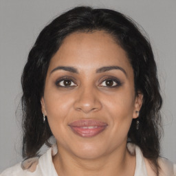 Joyful black adult female with medium  brown hair and brown eyes