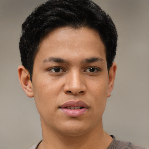 Joyful asian young-adult male with short  black hair and brown eyes
