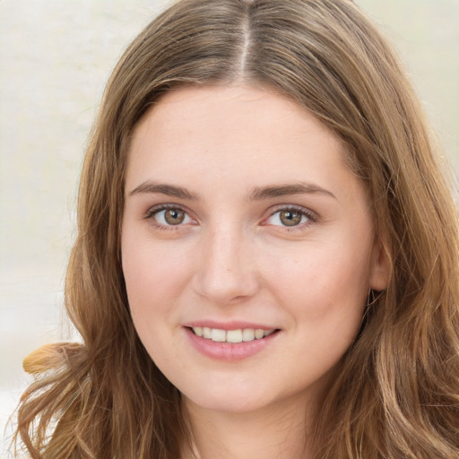 Joyful white young-adult female with long  brown hair and green eyes