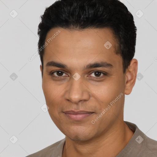 Joyful latino young-adult male with short  black hair and brown eyes