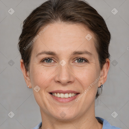 Joyful white adult female with short  brown hair and grey eyes