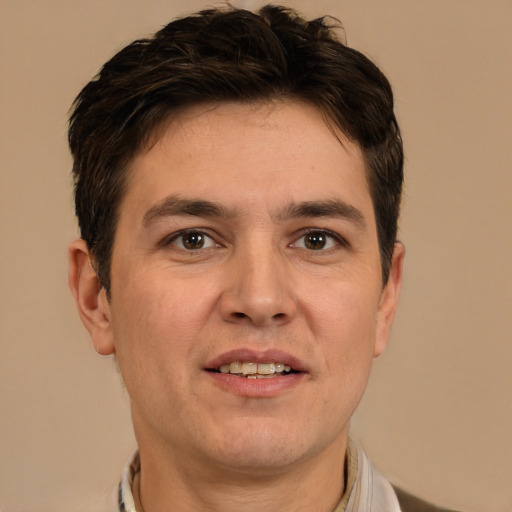 Joyful white adult male with short  brown hair and brown eyes