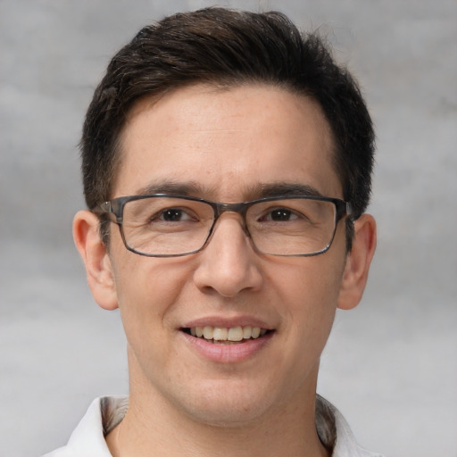 Joyful white adult male with short  brown hair and brown eyes