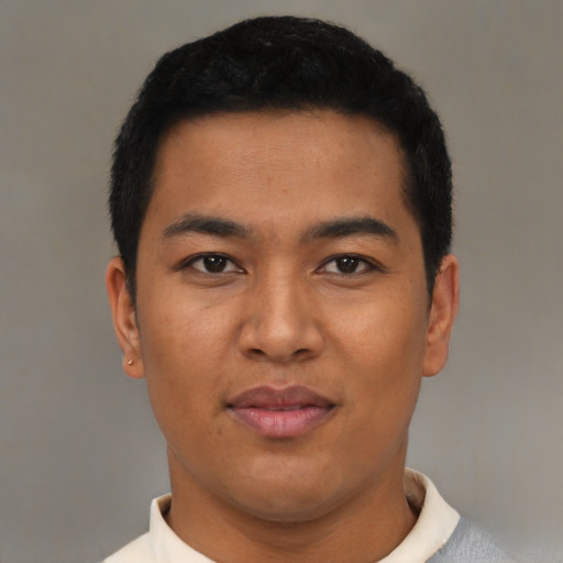Joyful latino young-adult male with short  black hair and brown eyes