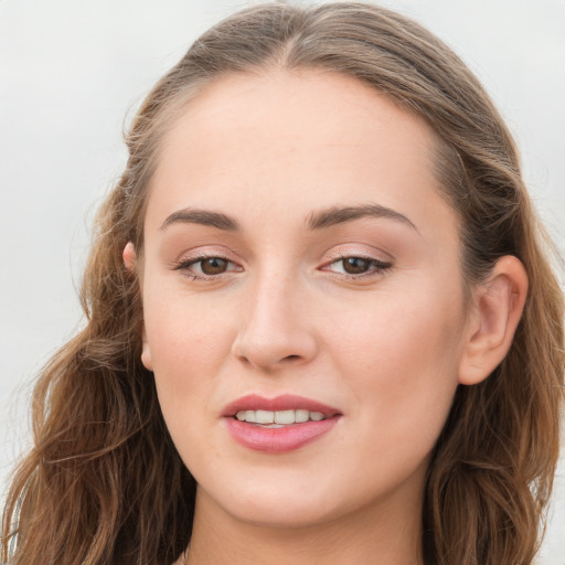 Joyful white young-adult female with long  brown hair and blue eyes