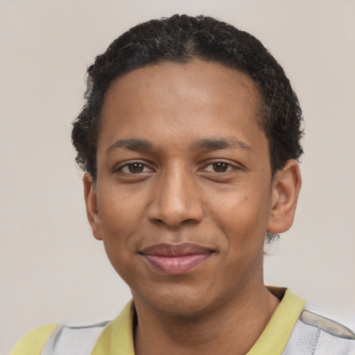 Joyful black young-adult male with short  black hair and brown eyes