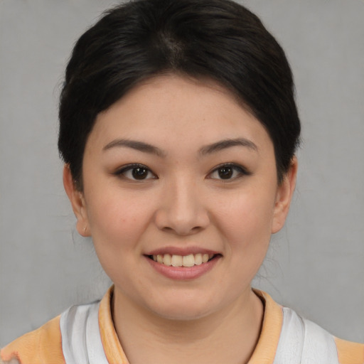 Joyful asian young-adult female with short  brown hair and brown eyes