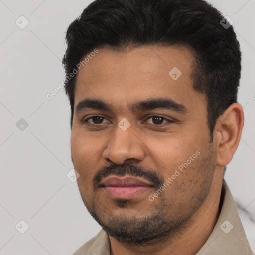 Joyful latino young-adult male with short  black hair and brown eyes