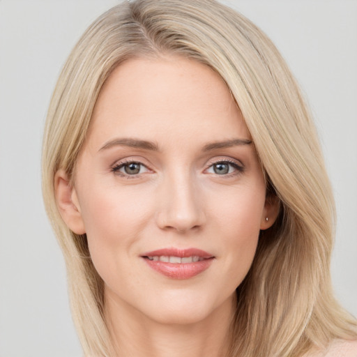 Joyful white young-adult female with long  brown hair and blue eyes