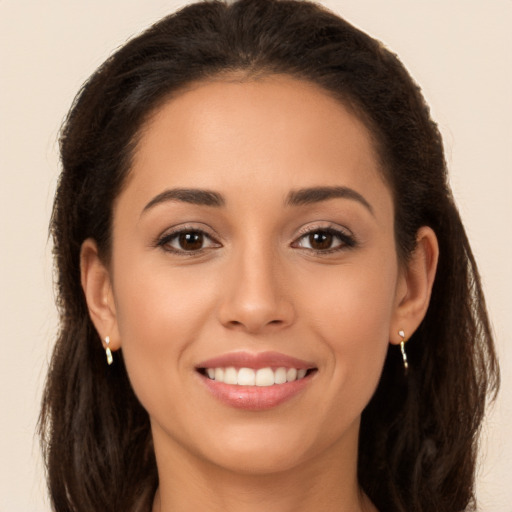 Joyful white young-adult female with long  brown hair and brown eyes