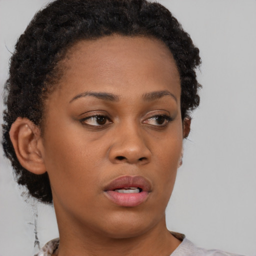 Neutral black young-adult female with short  brown hair and brown eyes