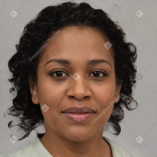 Joyful black adult female with medium  brown hair and brown eyes