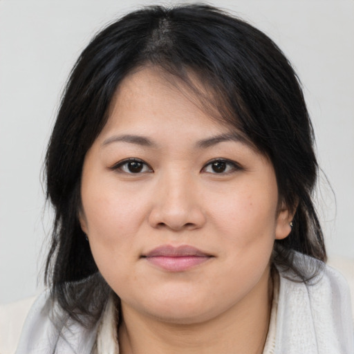 Joyful asian young-adult female with medium  brown hair and brown eyes