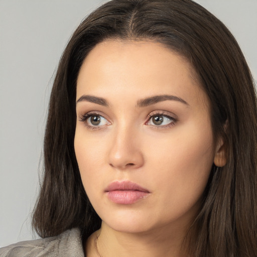 Neutral white young-adult female with long  brown hair and brown eyes