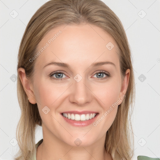 Joyful white young-adult female with long  brown hair and blue eyes