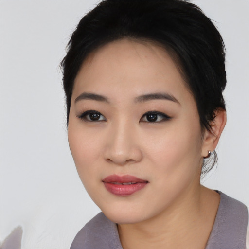 Joyful asian young-adult female with medium  black hair and brown eyes