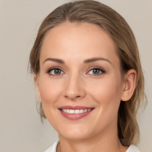 Joyful white young-adult female with medium  brown hair and brown eyes