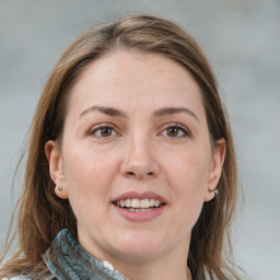 Joyful white adult female with medium  brown hair and grey eyes