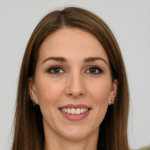 Joyful white young-adult female with long  brown hair and green eyes