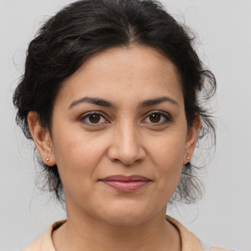 Joyful white adult female with medium  brown hair and brown eyes