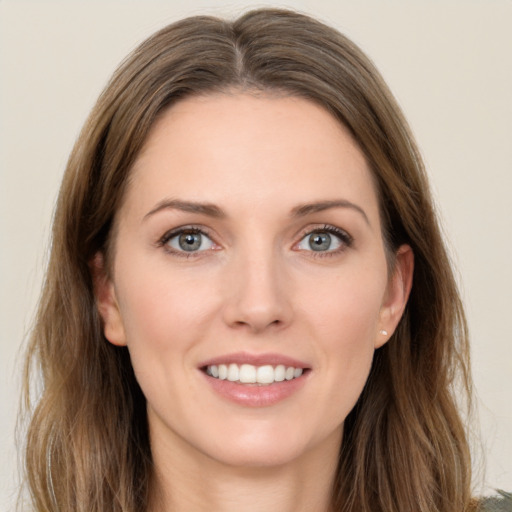 Joyful white young-adult female with long  brown hair and grey eyes