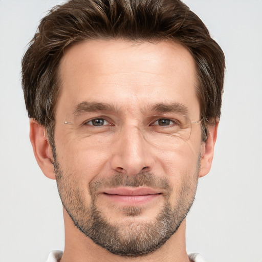 Joyful white adult male with short  brown hair and grey eyes